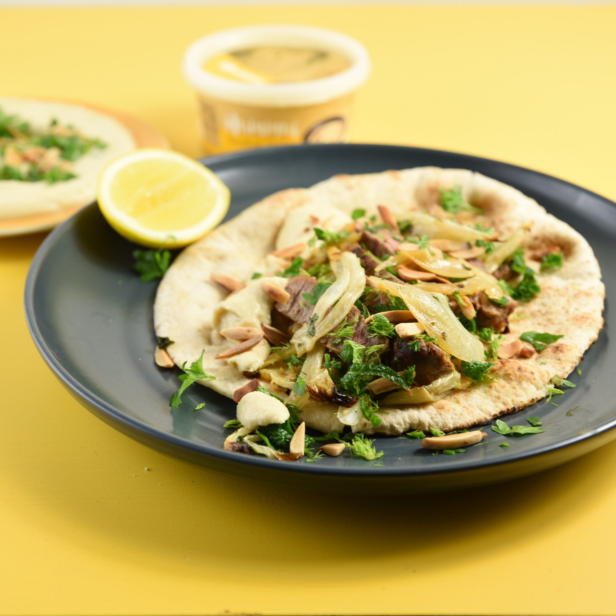 Roasted fennel wrapped with garlicky lemon hummus and steak with Alamir Bakery Hummus & Pita Bread