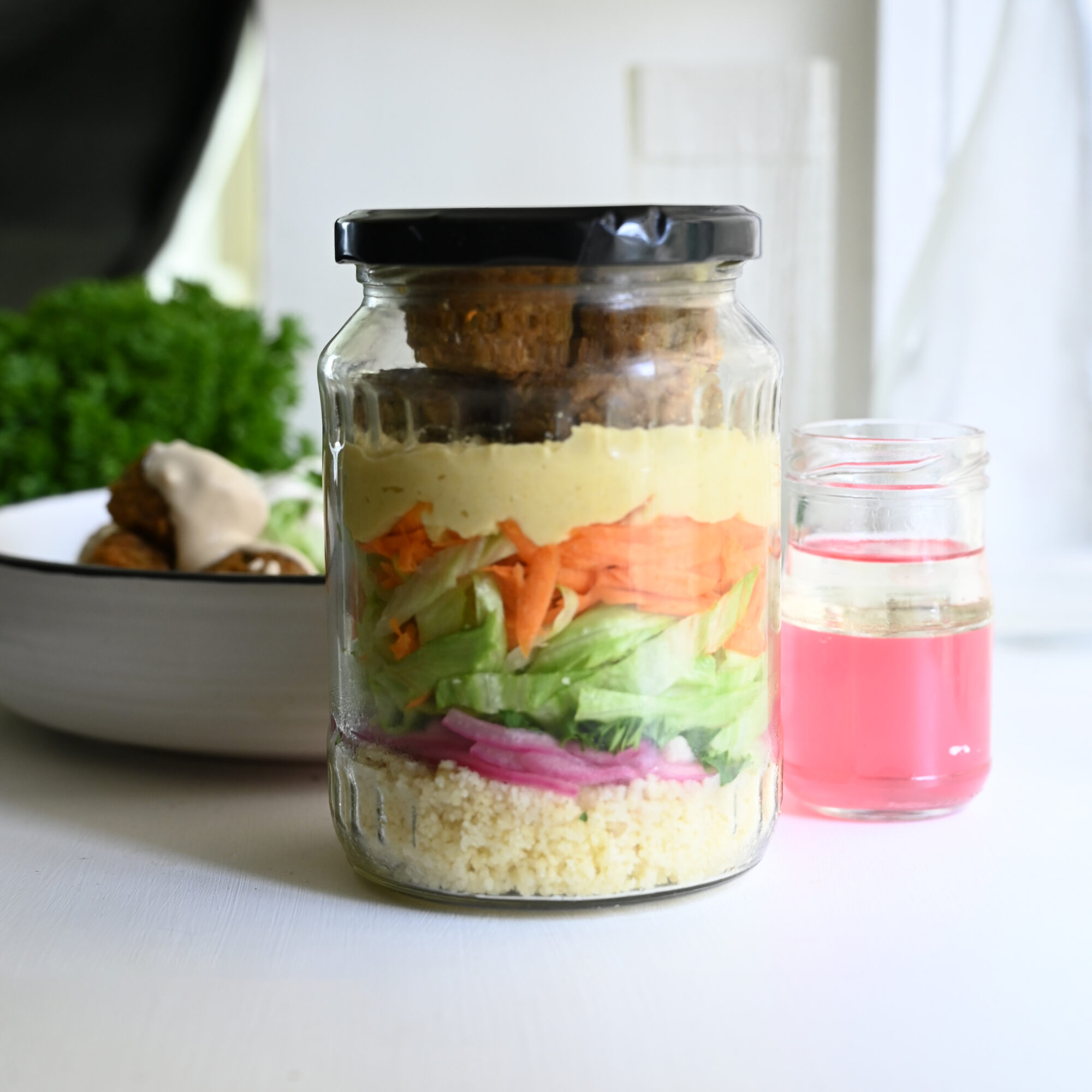 Falafel and couscous layered in a jar